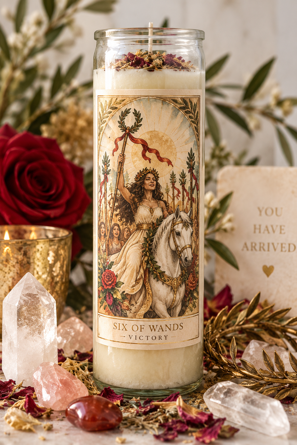 The Arcana Flame ritual set featuring a feminine Six of Wands tarot candle with crystals and herbs