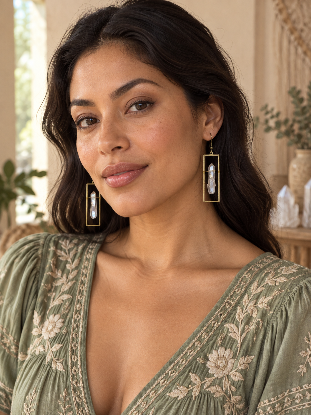 Latina model wearing Celestial Window Angel Aura Earrings with a sage embroidered blouse