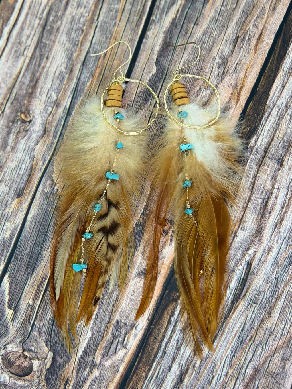 Pair of Desert Sky Feather Hoop Earrings on a rustic wood background