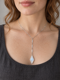 Fair-skinned model wearing the sterling silver Goddess Light Rainbow Moonstone Y Necklace
