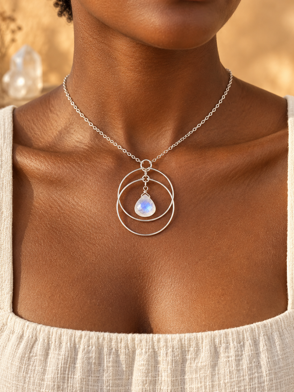 Dark-skinned model wearing the Lunar Orbit Rainbow Moonstone Necklace