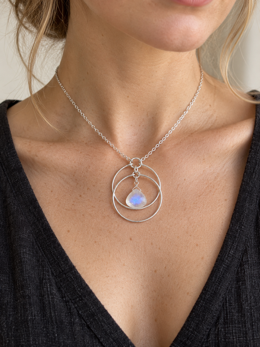 Fair-skinned model wearing the Lunar Orbit Rainbow Moonstone Necklace