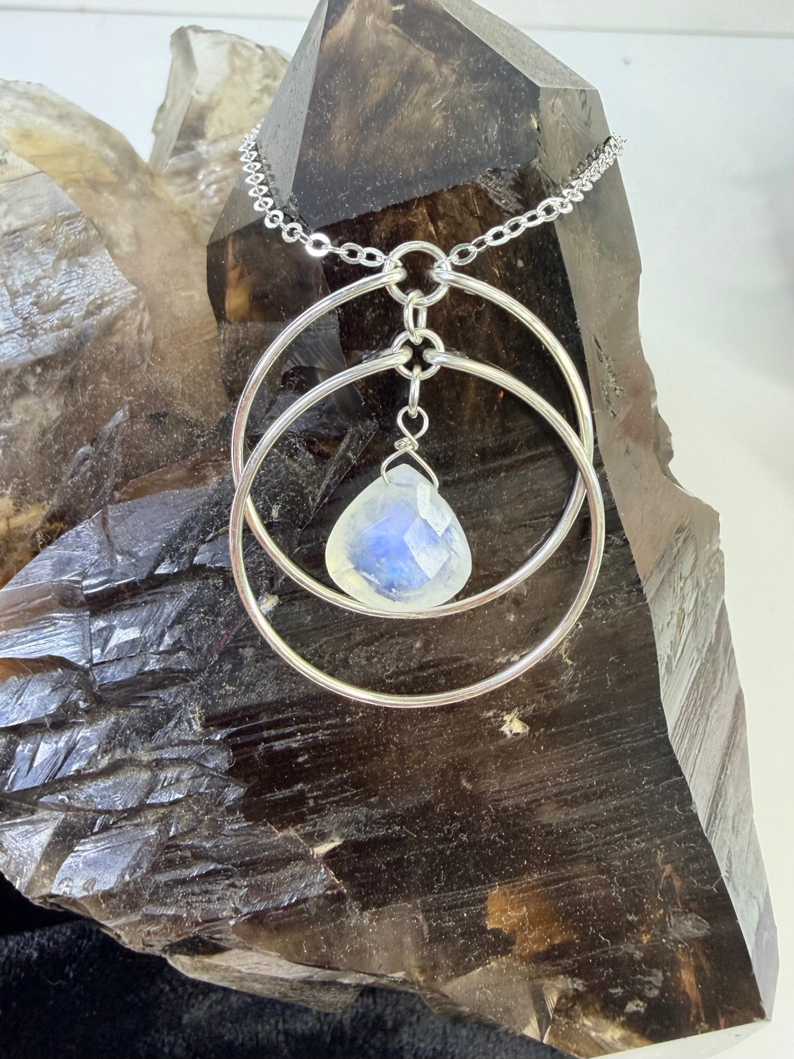 Detail of the rainbow moonstone pendant and hand-formed silver circles