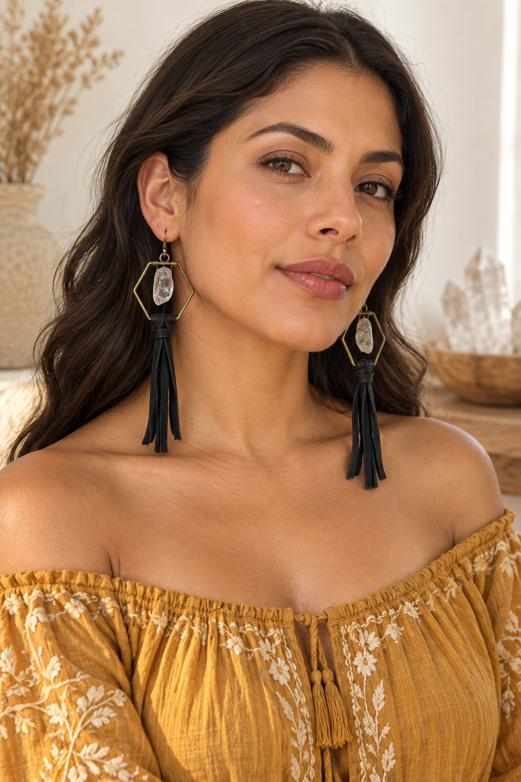 Latina model wearing Queen Bee Clear Quartz Tassel Earrings with a golden embroidered blouse